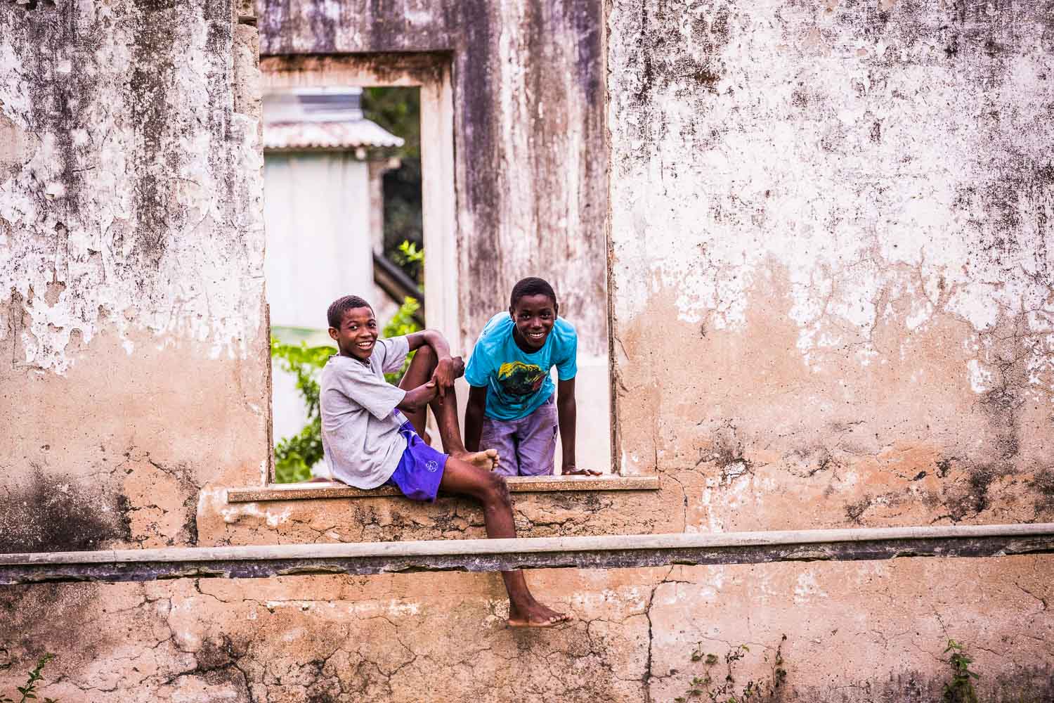https://www.trackssafaris.co.uk/wp-content/uploads/2022/06/6_-PRINCIPE-ISLAND-Local-boys-relaxing-in-old-ruins-copyright-Scott-Ramsay-copy.jpg