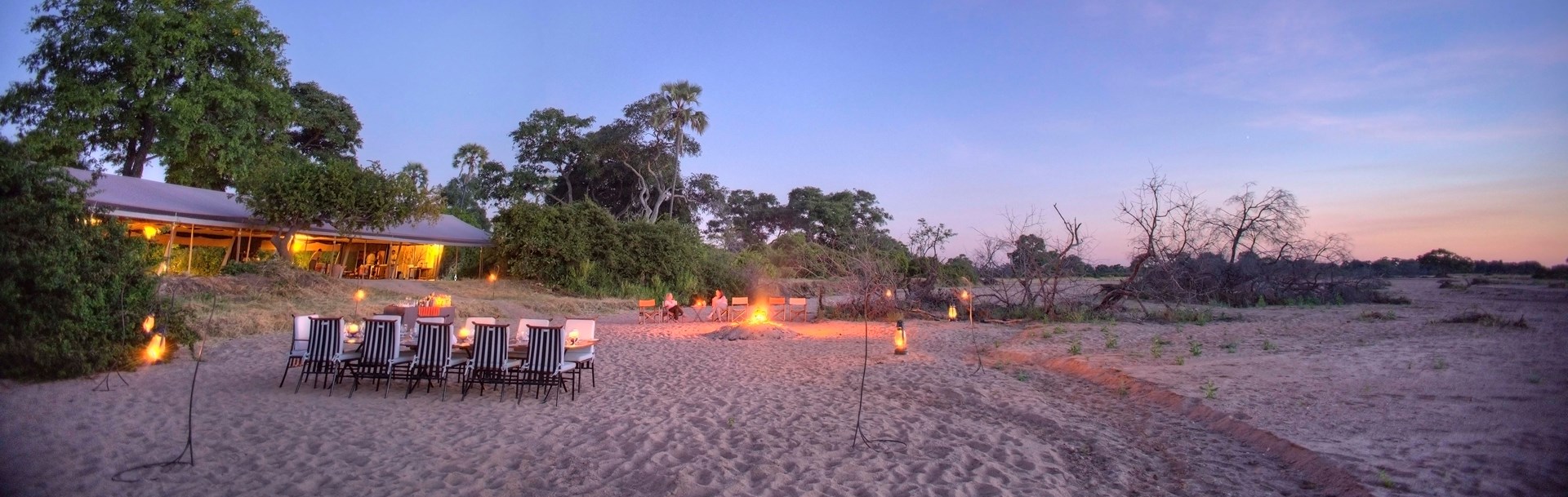 /wp-content/uploads/2022/07/10-kwihala-sundowners-and-dinner-set-up-around-fire.jpg