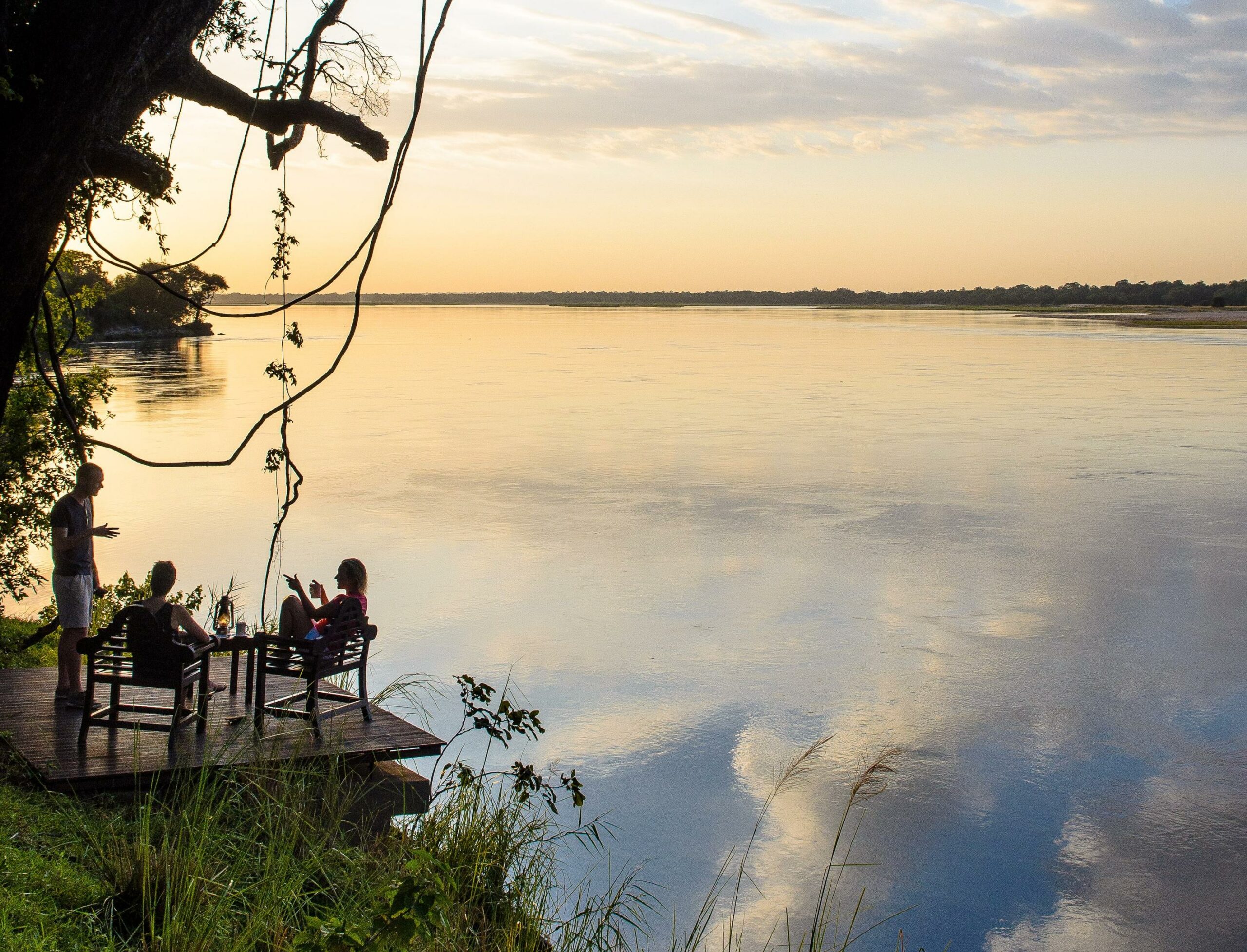 https://www.trackssafaris.co.uk/wp-content/uploads/2022/07/Baines-River-Camp-Sundowners_1-scaled.jpg