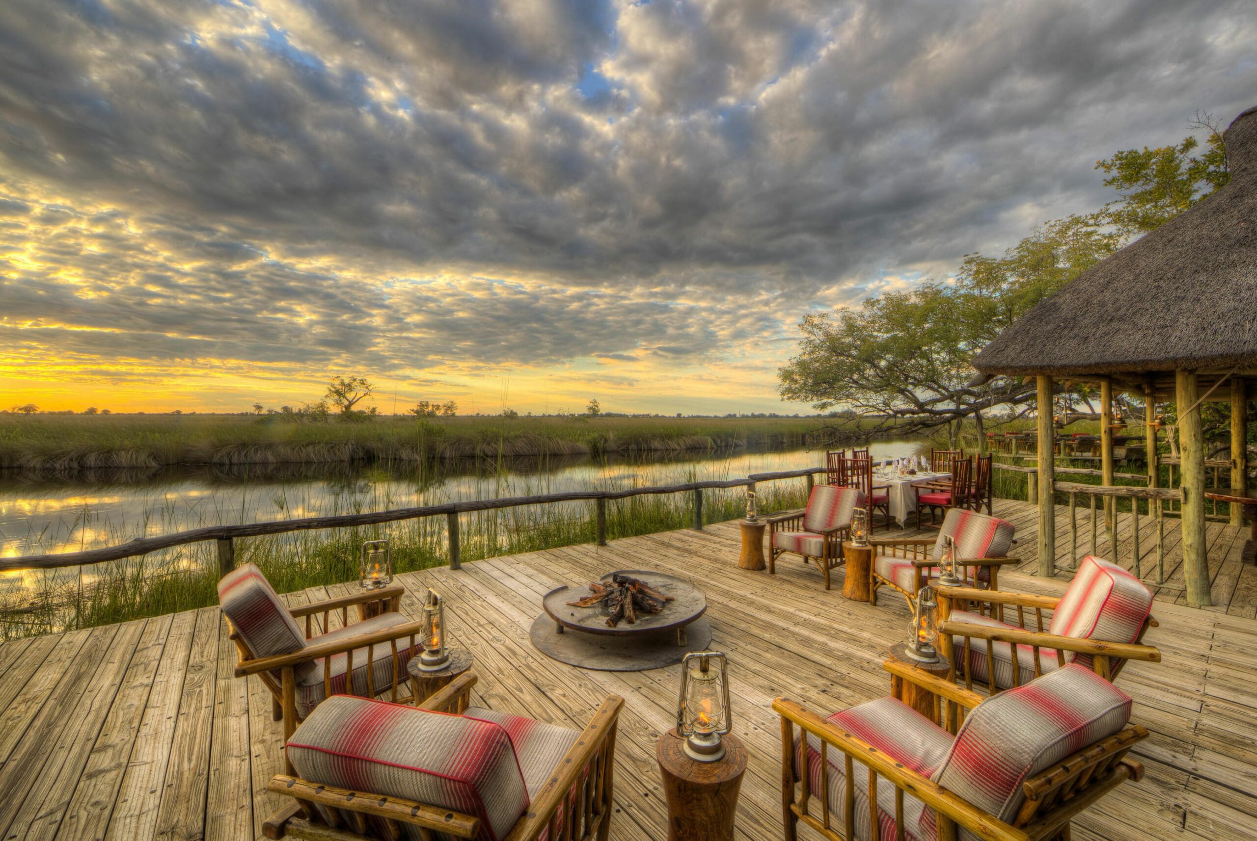/wp-content/uploads/2022/07/Camp-Xakanaxa-Dining-Deck-Fire-Place--scaled.jpg