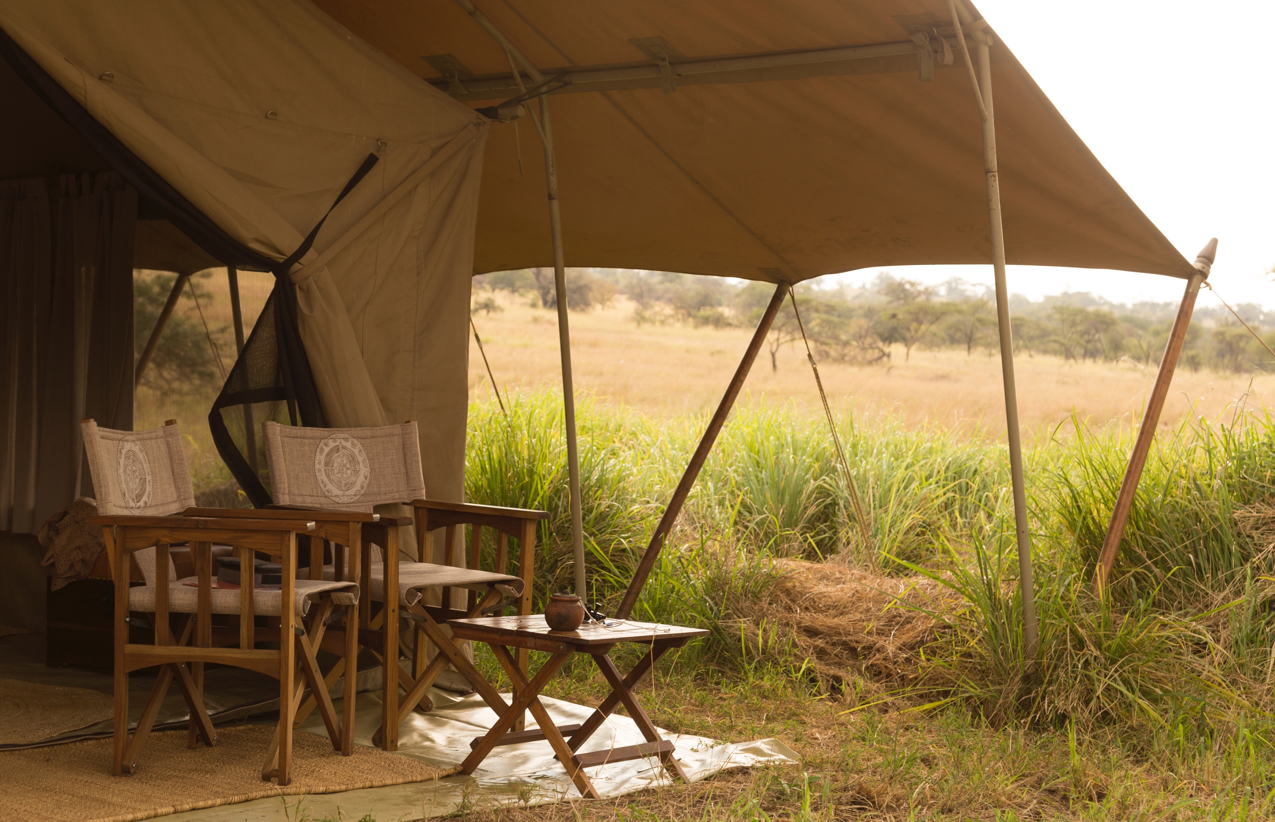 /wp-content/uploads/2022/07/SerengetiSafariCamp-chairs-by-tent.jpg