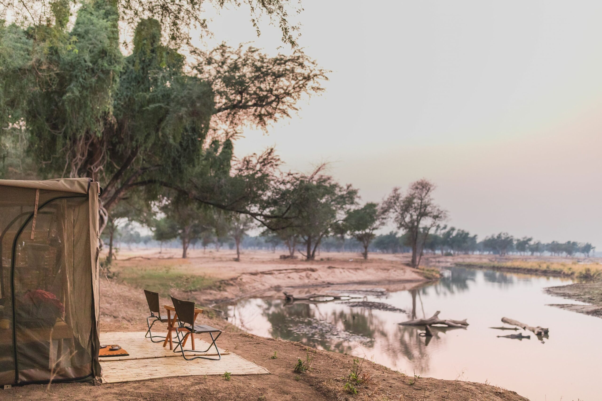 https://www.trackssafaris.co.uk/wp-content/uploads/2022/07/tent-overlooking-river-scaled.jpg